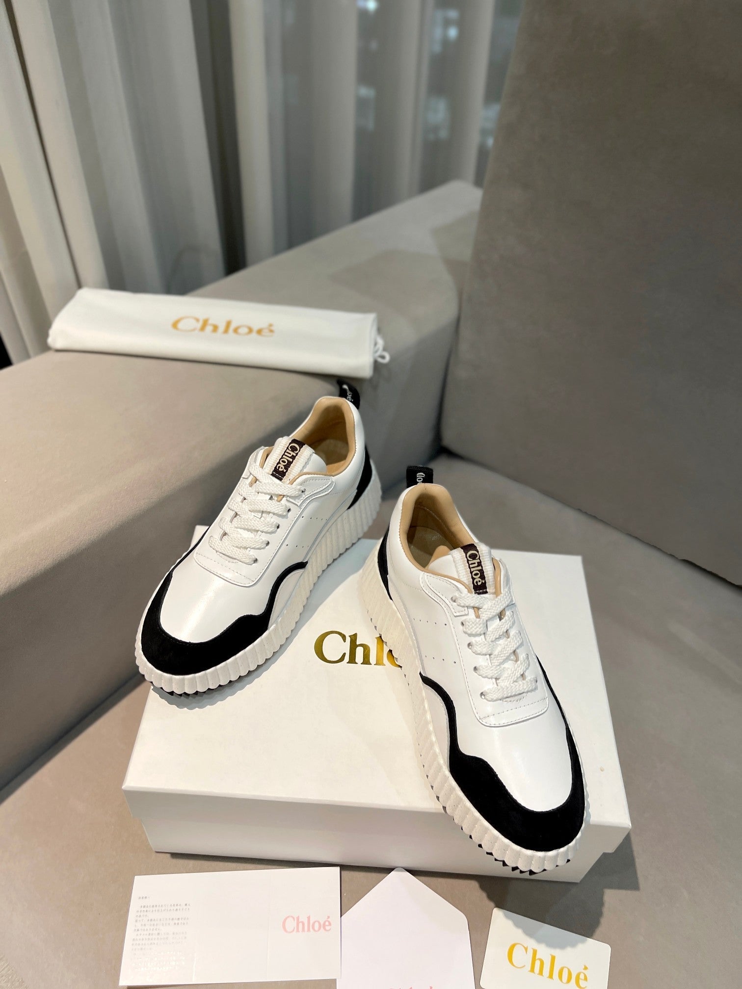 CHLOÉ NAMA SNEAKER IN WHITE LAMBSKIN AND BLACK SUEDE
