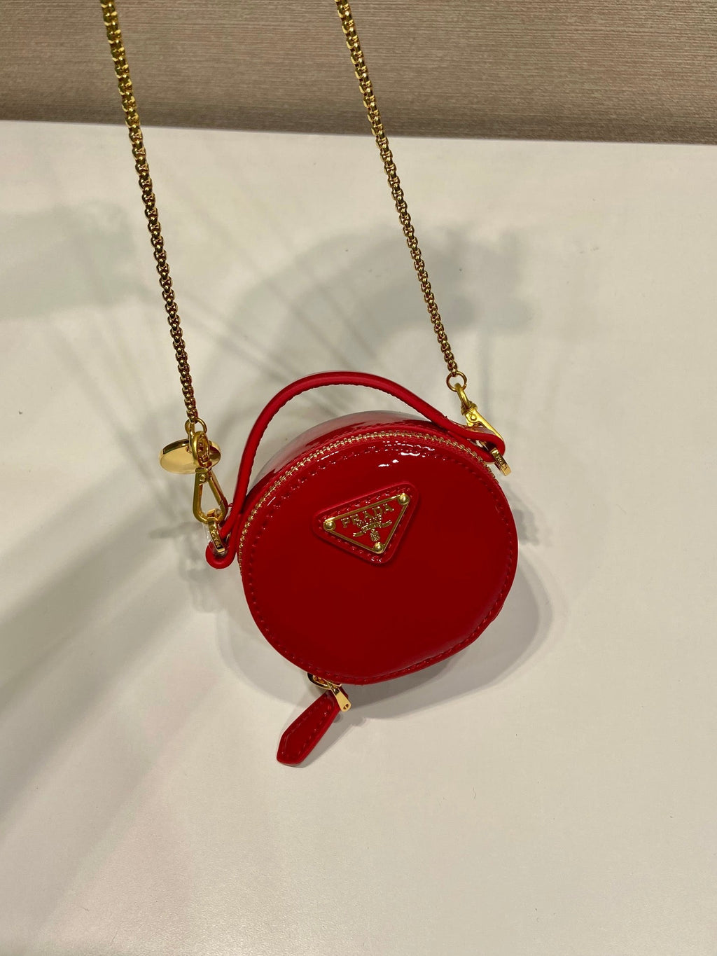 MINI ROUND BAG 8 IN RED GLOSSY CALFSKIN GOLD HARDWARE