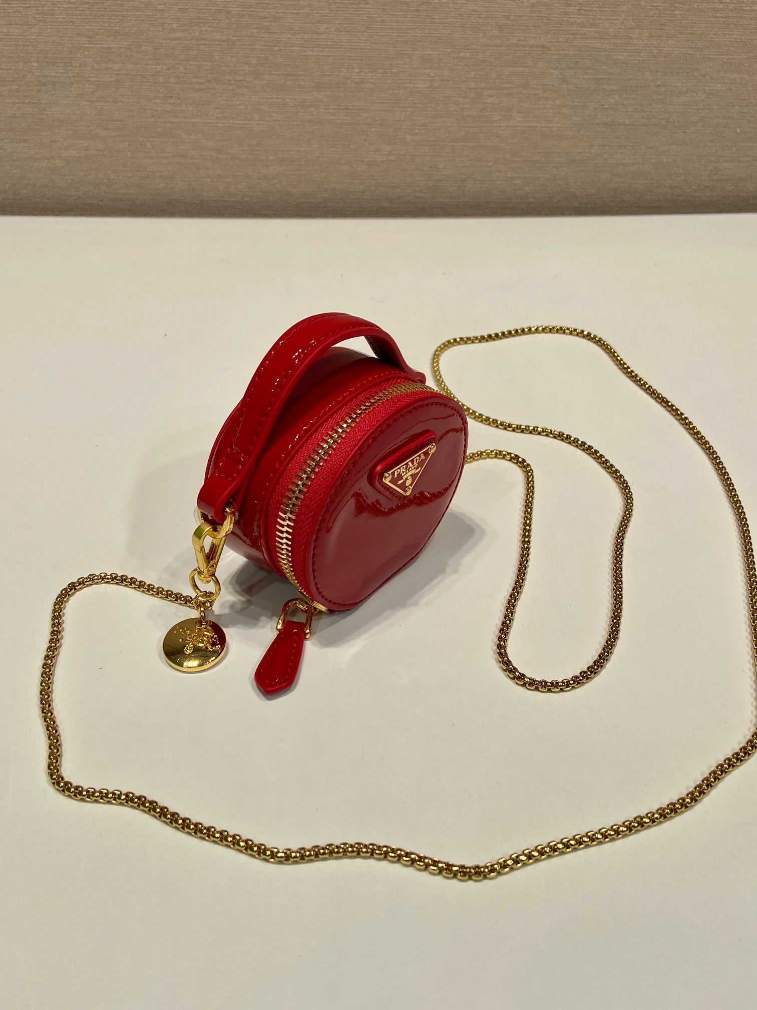 MINI ROUND BAG 8 IN RED GLOSSY CALFSKIN GOLD HARDWARE