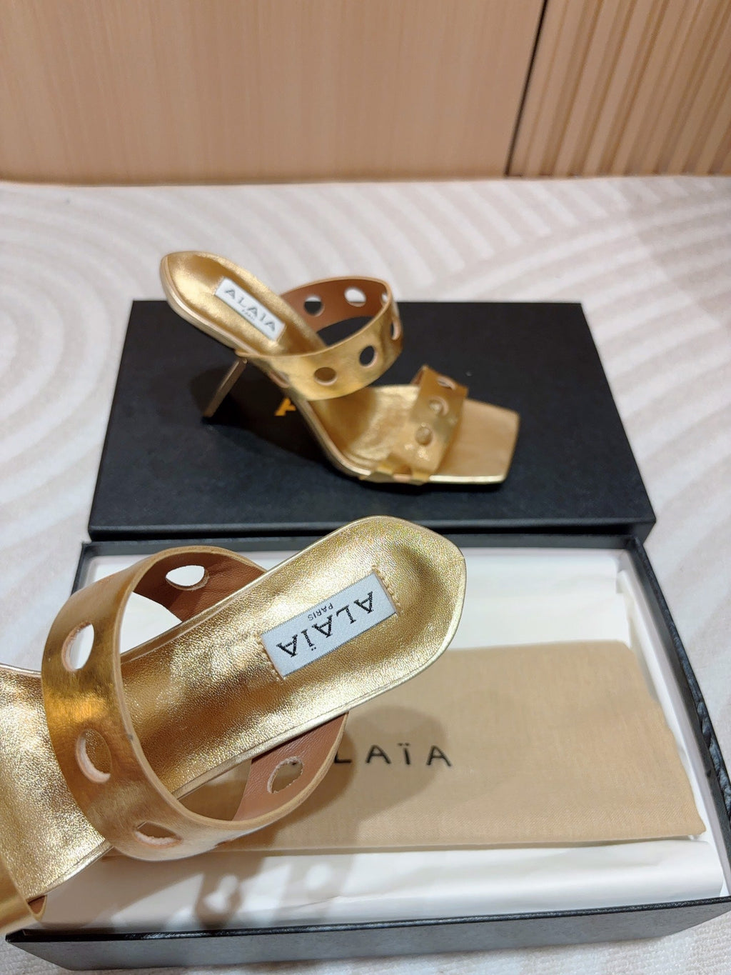 ALAIA TWO-STRAPS HIGH HEEL SANDALS IN GOLDEN PATENT LAMBSKIN