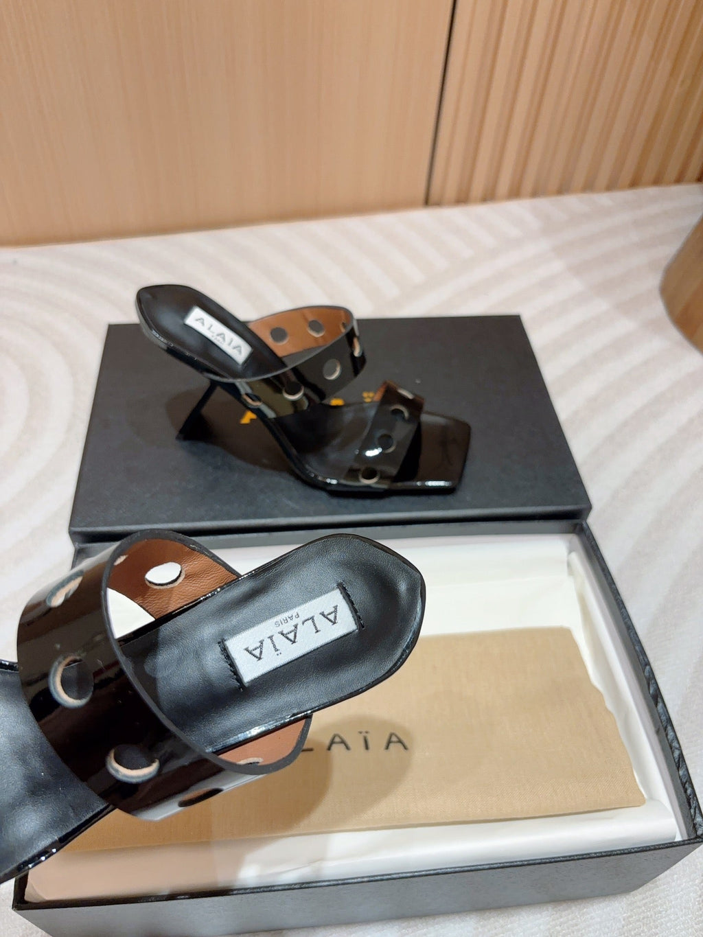 ALAIA TWO-STRAPS HIGH HEEL SANDALS IN BLACK PATENT LAMBSKIN