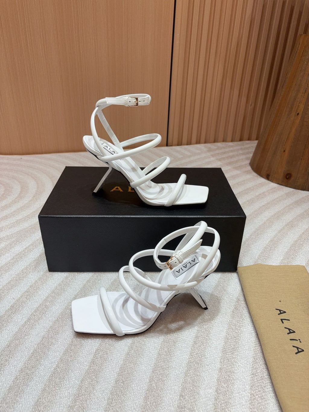 ALAIA THREE-STRAPS HIGH HEEL SANDALS IN WHITE PATENT LAMBSKIN