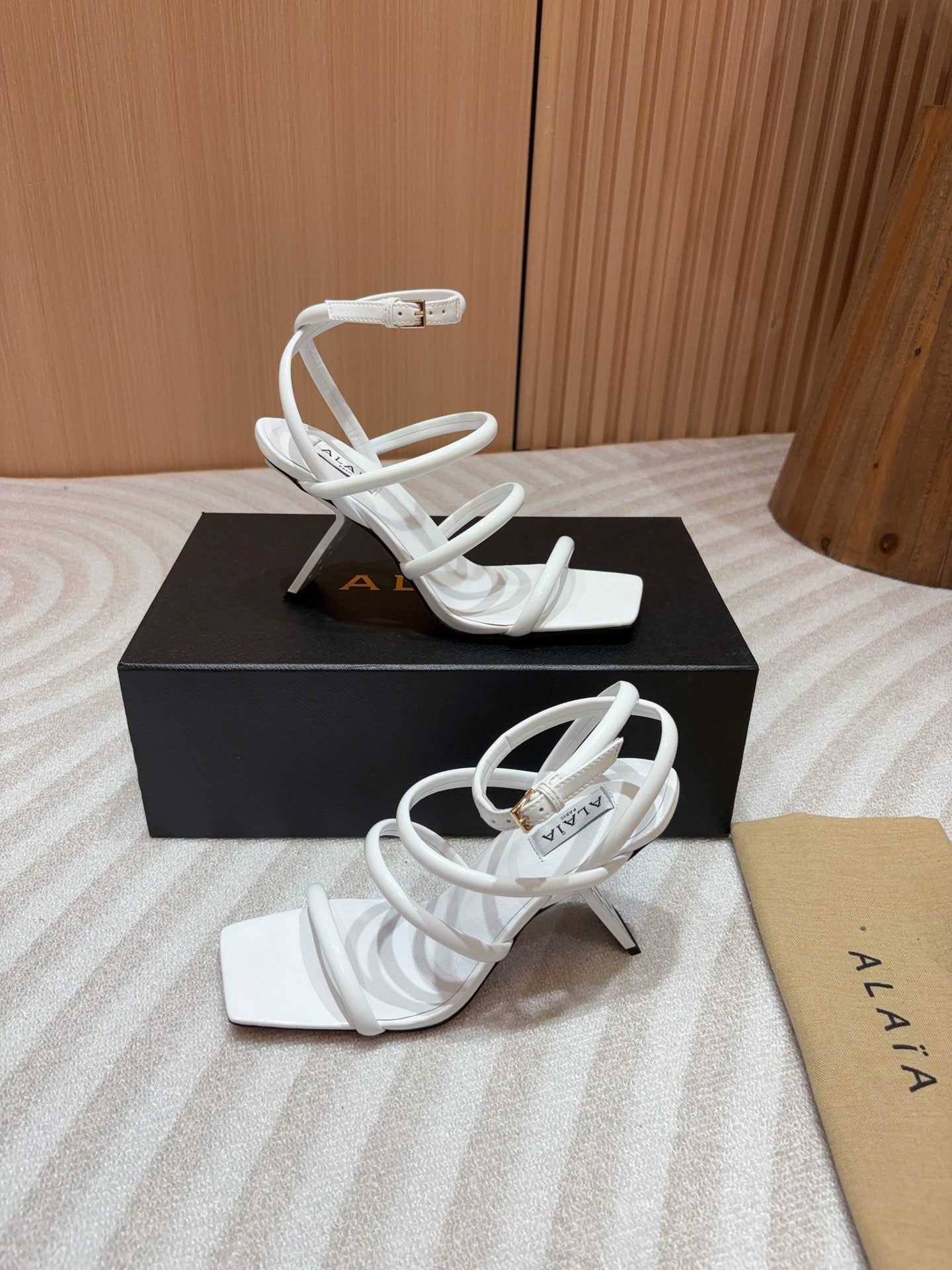 ALAIA THREE-STRAPS HIGH HEEL SANDALS IN WHITE PATENT LAMBSKIN
