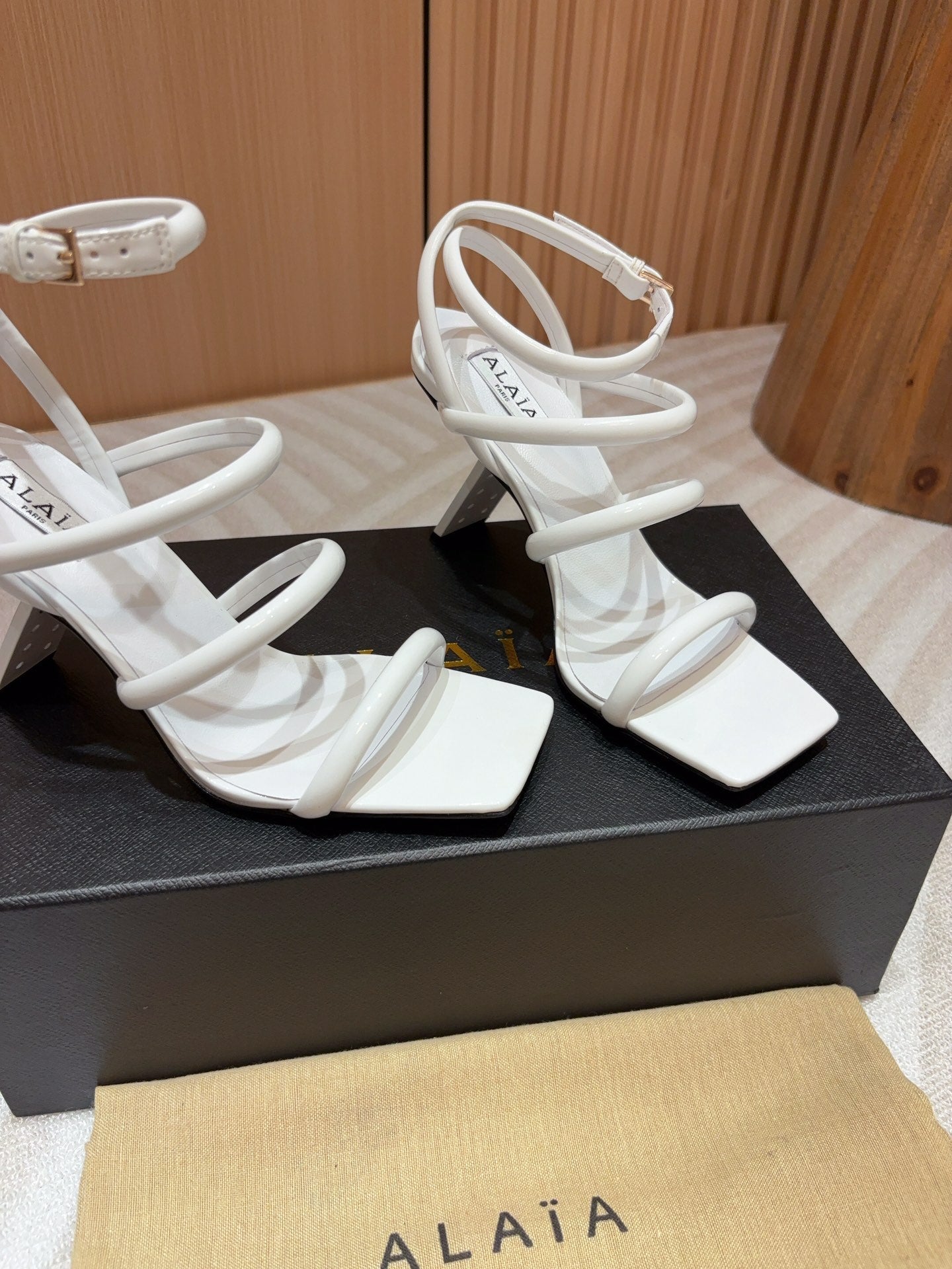 ALAIA THREE-STRAPS HIGH HEEL SANDALS IN WHITE PATENT LAMBSKIN