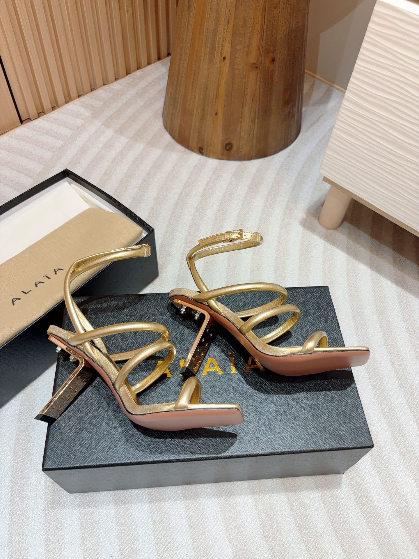 ALAIA THREE-STRAPS HIGH HEEL SANDALS IN GOLDEN PATENT LAMBSKIN