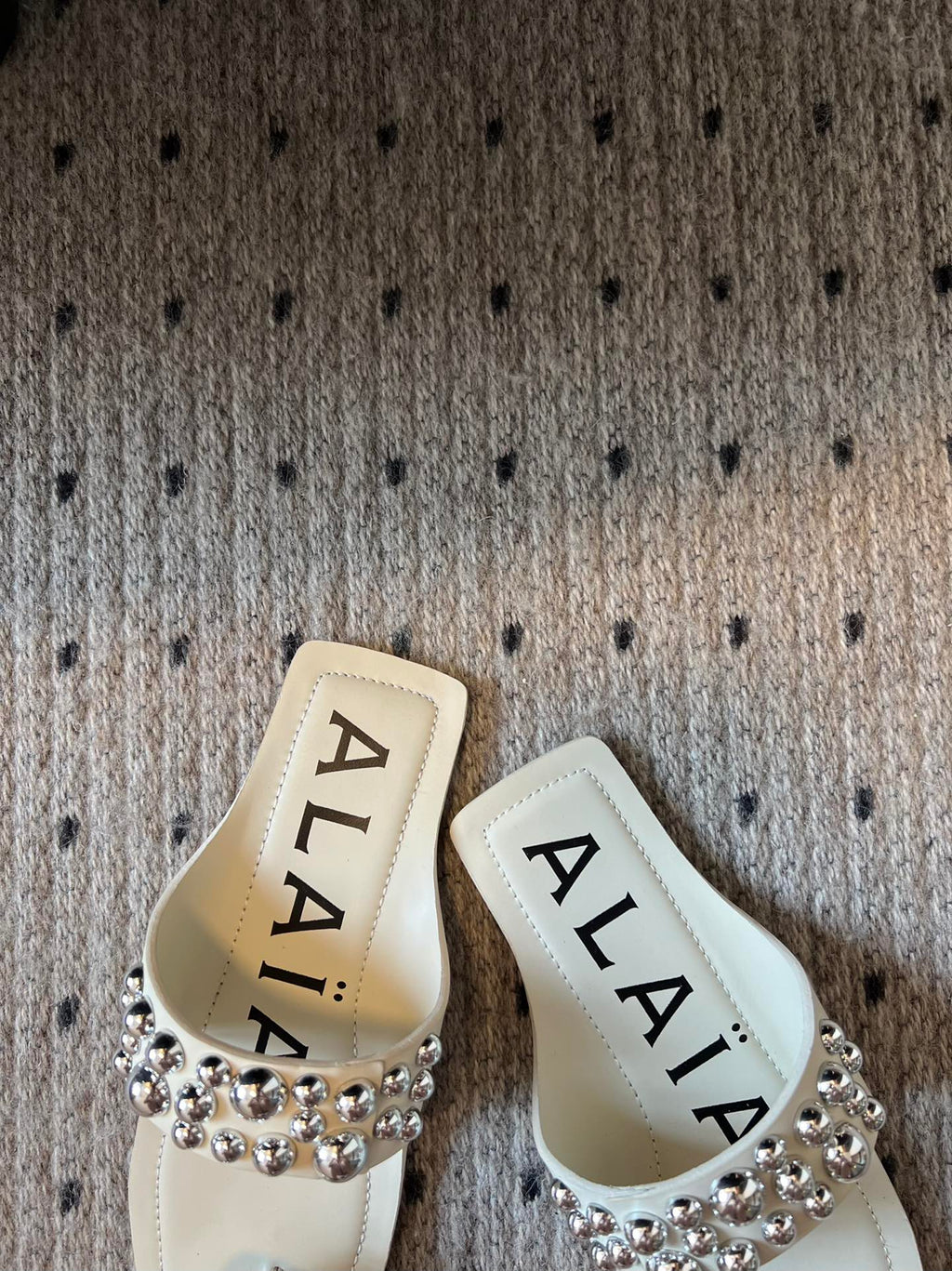 ALAIA FOLDED FLAT MULES WITH SPHERES ON WHITE CALFSKIN