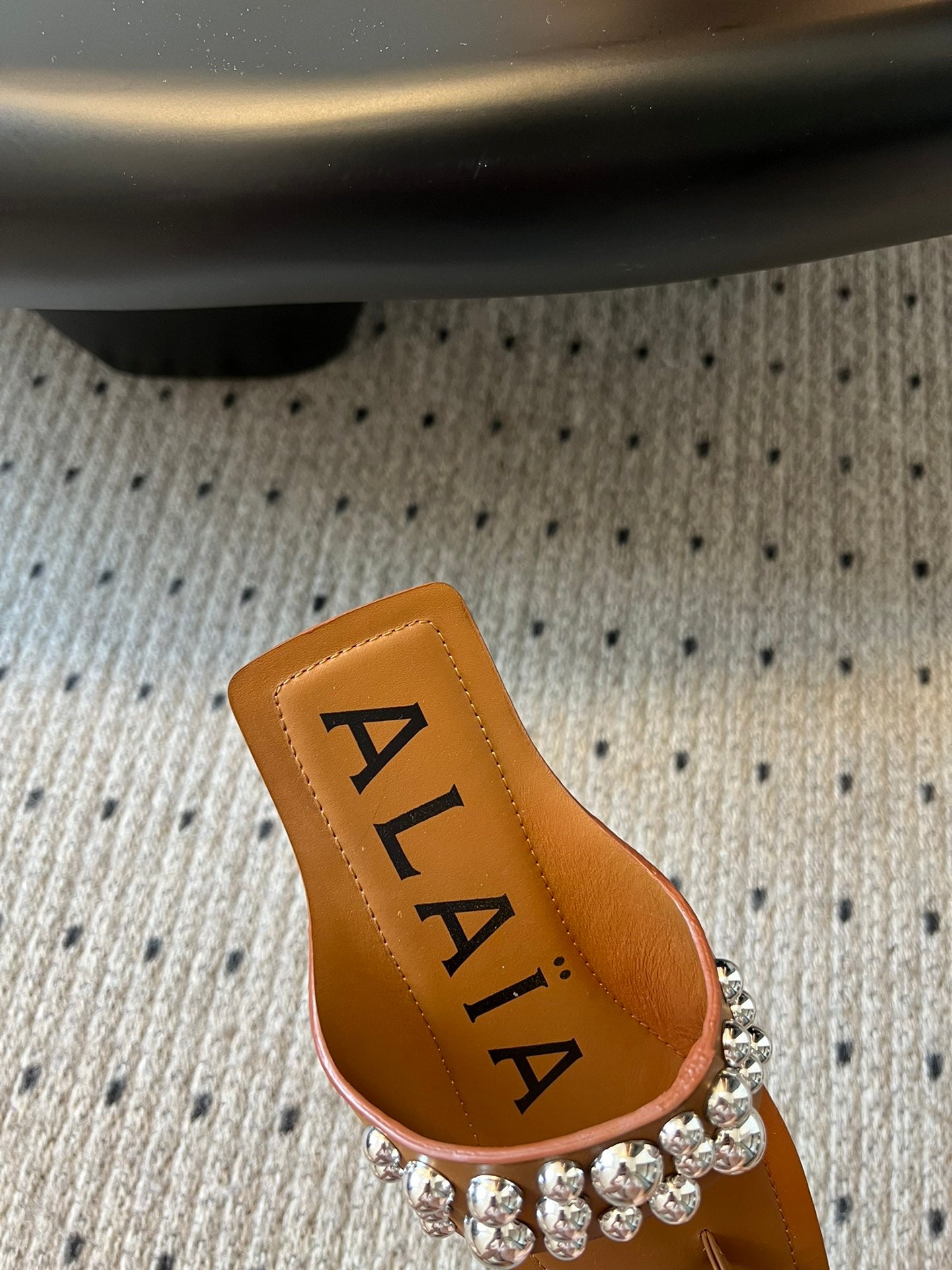ALAIA FOLDED FLAT MULES WITH SPHERES ON COPPER BROWN CALFSKIN