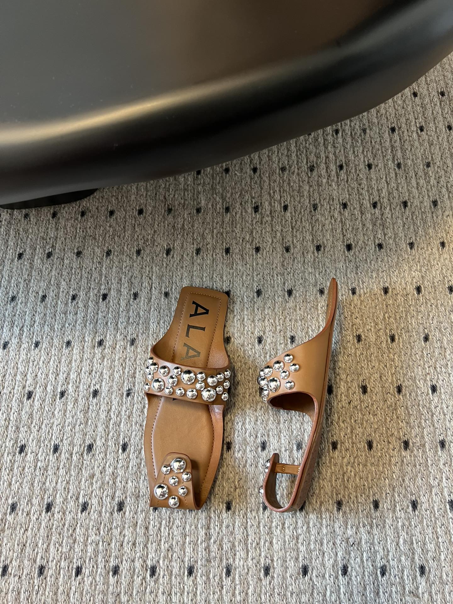 ALAIA FOLDED FLAT MULES WITH SPHERES ON COPPER BROWN CALFSKIN