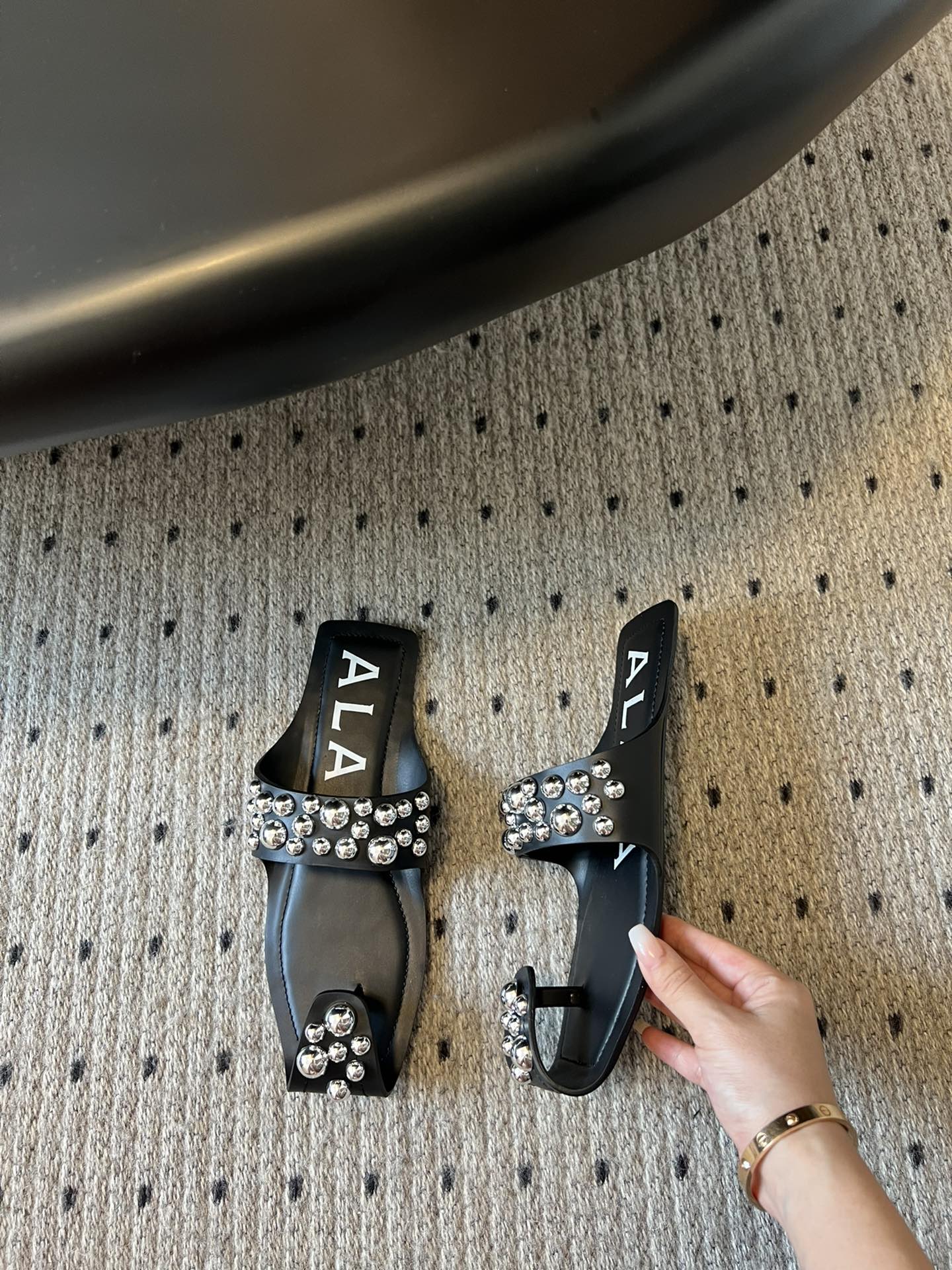 ALAIA FOLDED FLAT MULES WITH SPHERES ON BLACK CALFSKIN