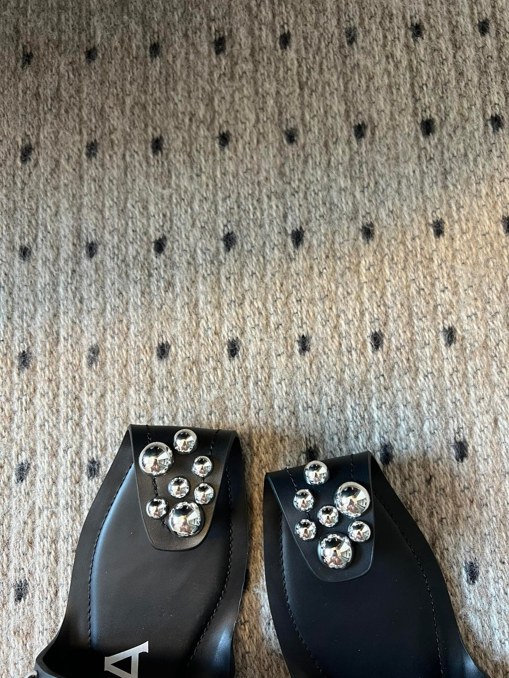 ALAIA FOLDED FLAT MULES WITH SPHERES ON BLACK CALFSKIN