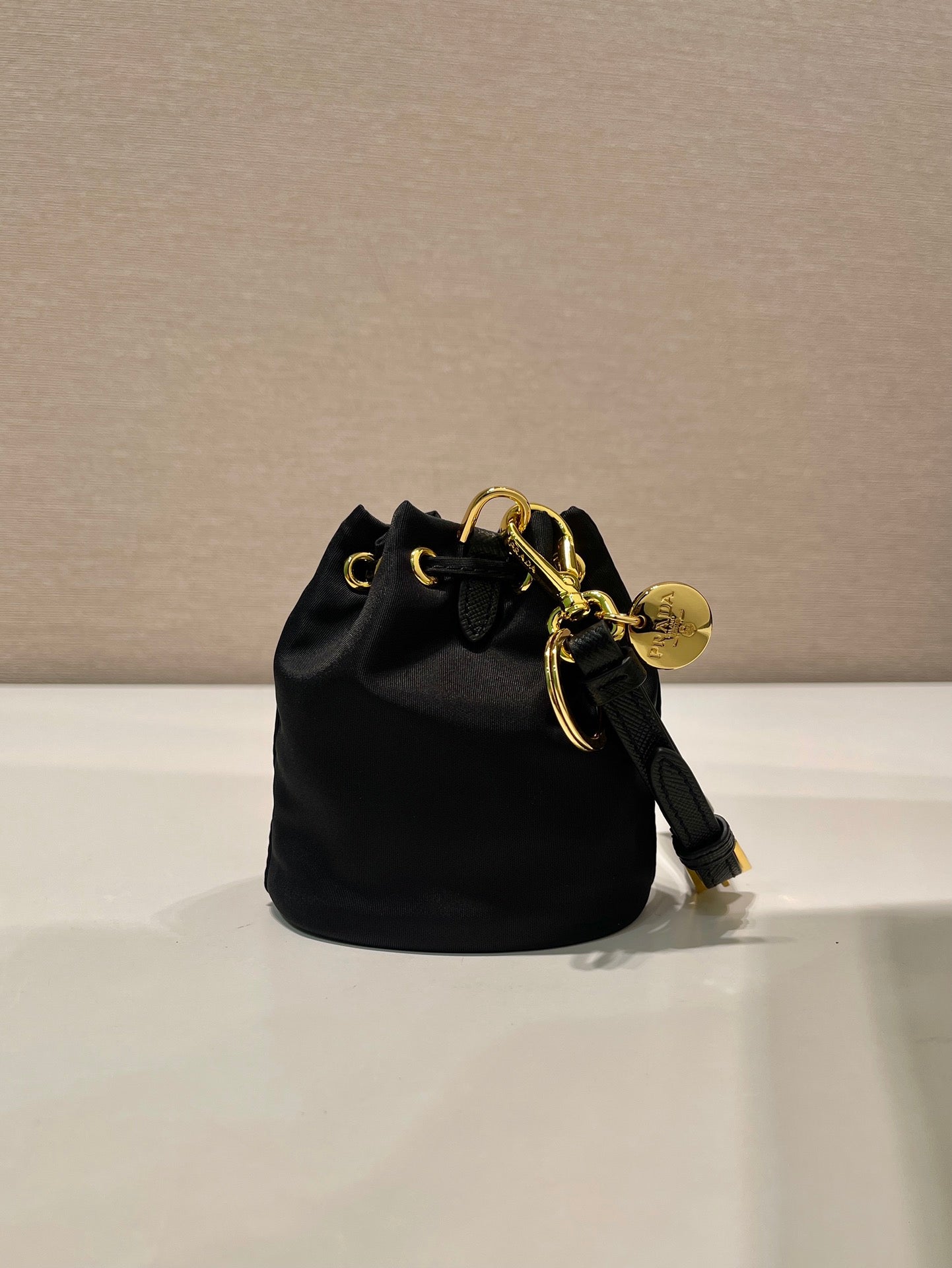 MINI BUCKET BAG 10 IN BLACK RE-NYLON AND SAFFIANO LEATHER STRAP