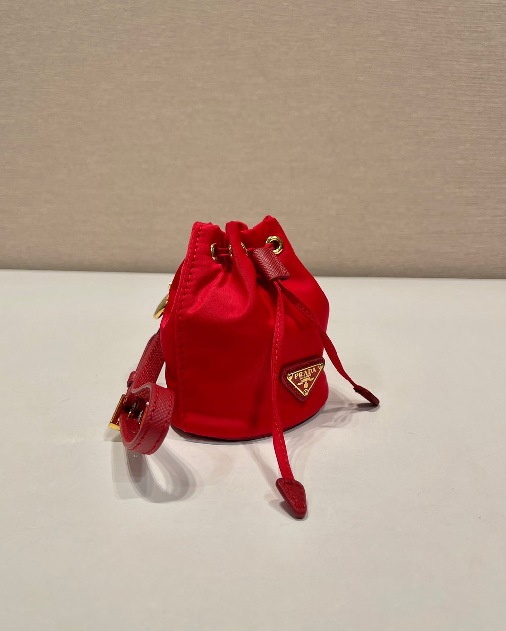 MINI BUCKET BAG 10 IN RED RE-NYLON AND SAFFIANO LEATHER STRAP