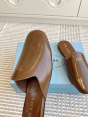 MULES IN BROWN GLOSSY SHEEPSKIN GOLD LETTERING LOGO