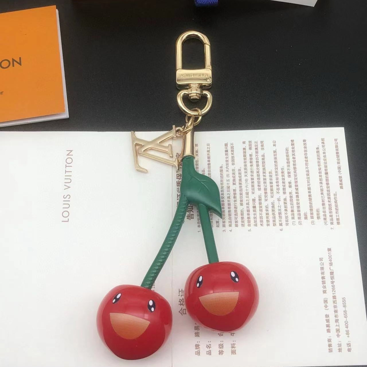 LV KEYCHAIN CHERRY IN RED RESIN AND METAL