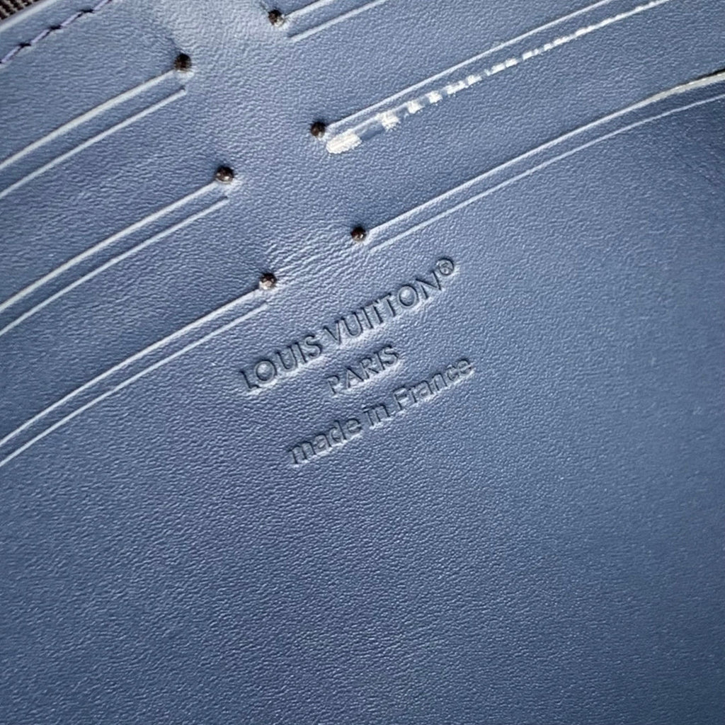 POCHETTE VOYAGE 27 IN DARK BLUE MONOGRAM ECLIPSE CALFSKIN EMBOSSED LOGO