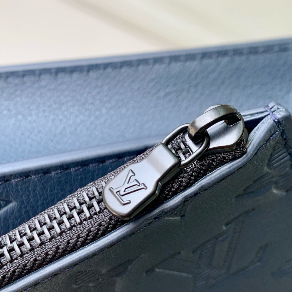 POCHETTE VOYAGE 22 IN DARK BLUE MONOGRAM SHADOW CALFSKIN