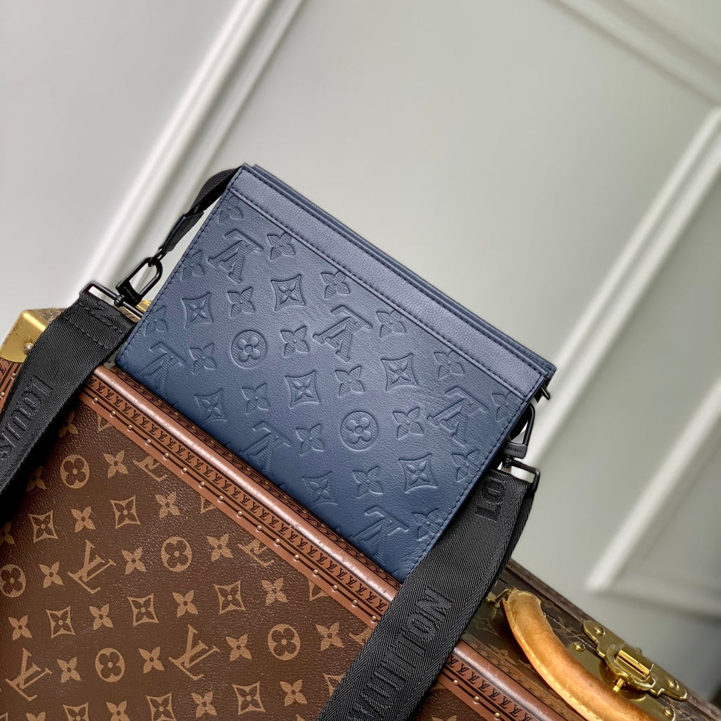 POCHETTE VOYAGE 22 IN DARK BLUE MONOGRAM SHADOW CALFSKIN