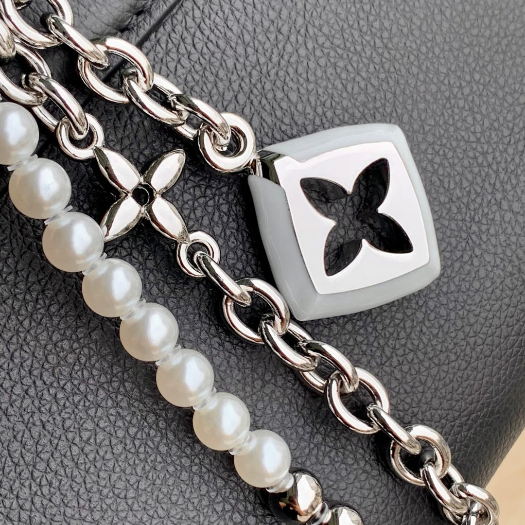 TWIST SLIM 19 IN BLACK TAURILLON CALFSKIN WITH PEARL CHAIN