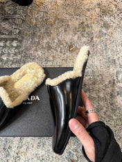 PRADA 25S CLOGS IN BLACK CALFSKIN AND BEIGE FUR-LINED