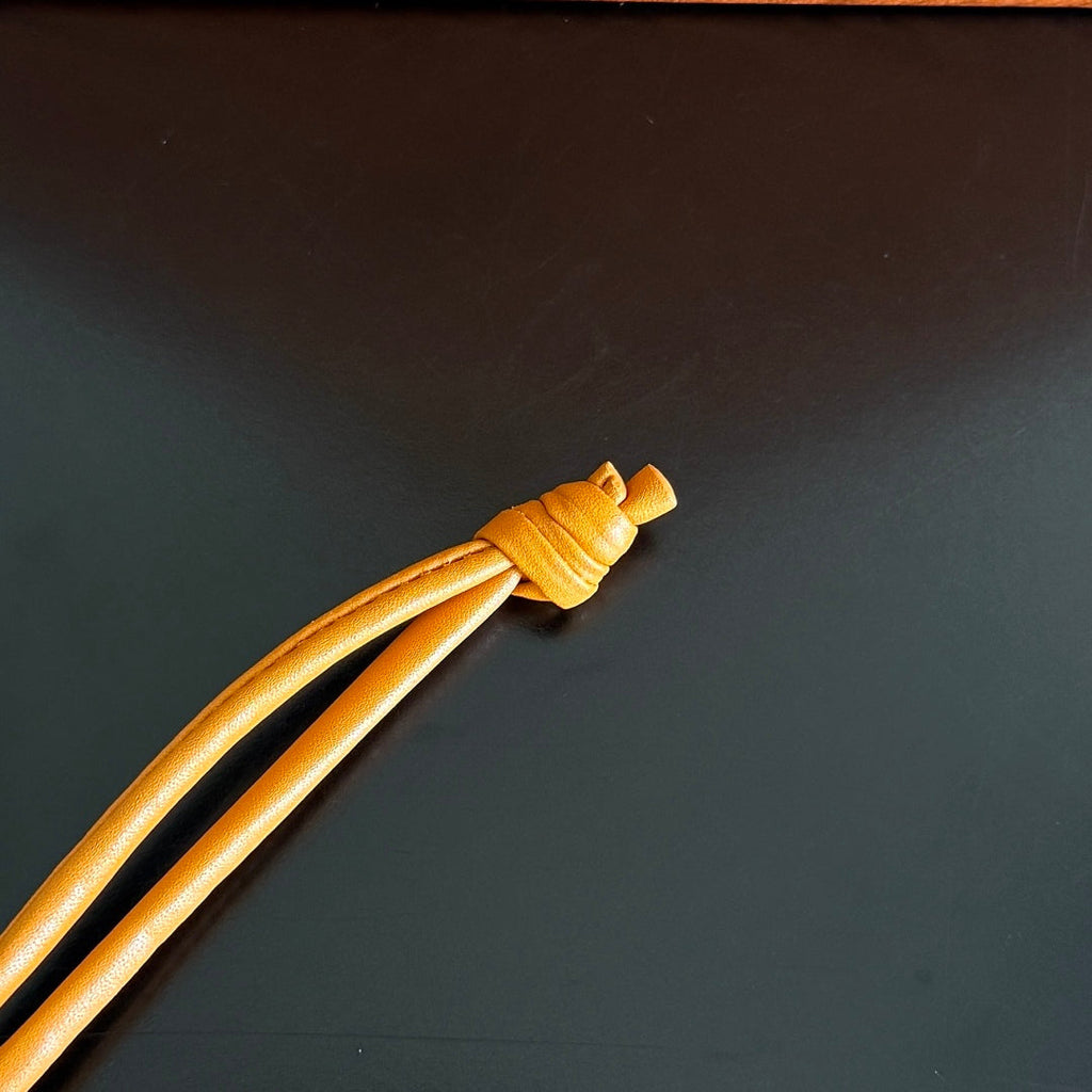 BOTTEGA VENETA 25S DOG CHARM IN BURNT ORANGE CALFSKIN