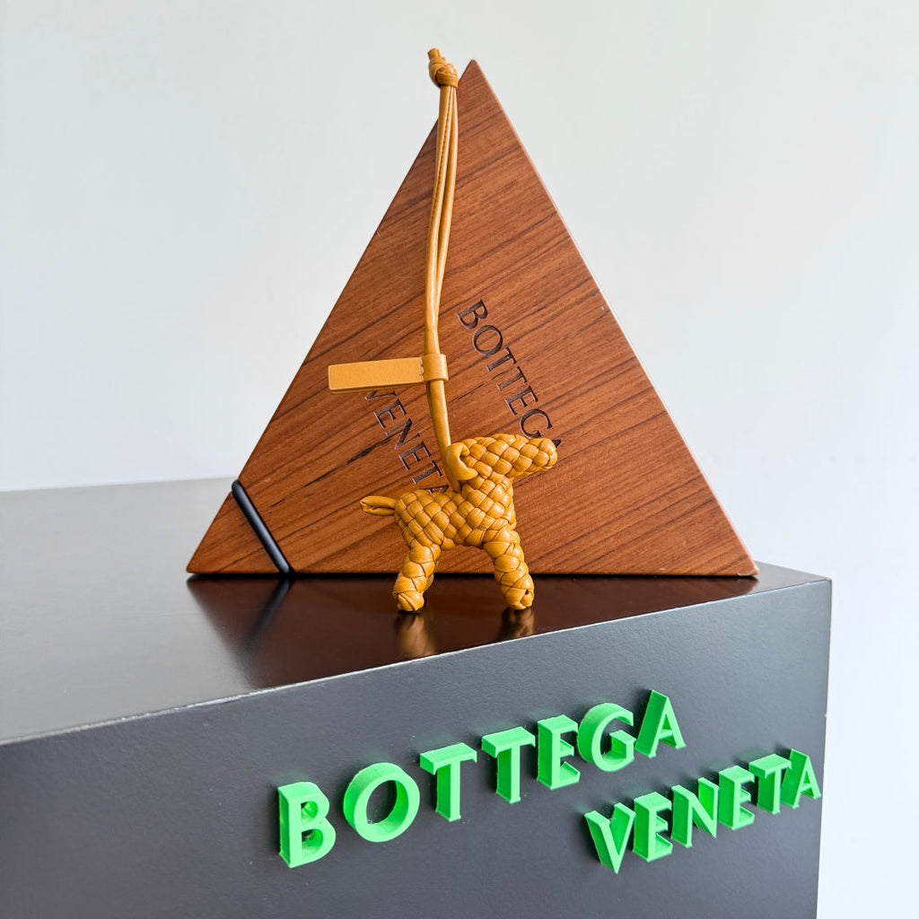 BOTTEGA VENETA 25S DOG CHARM IN BURNT ORANGE CALFSKIN