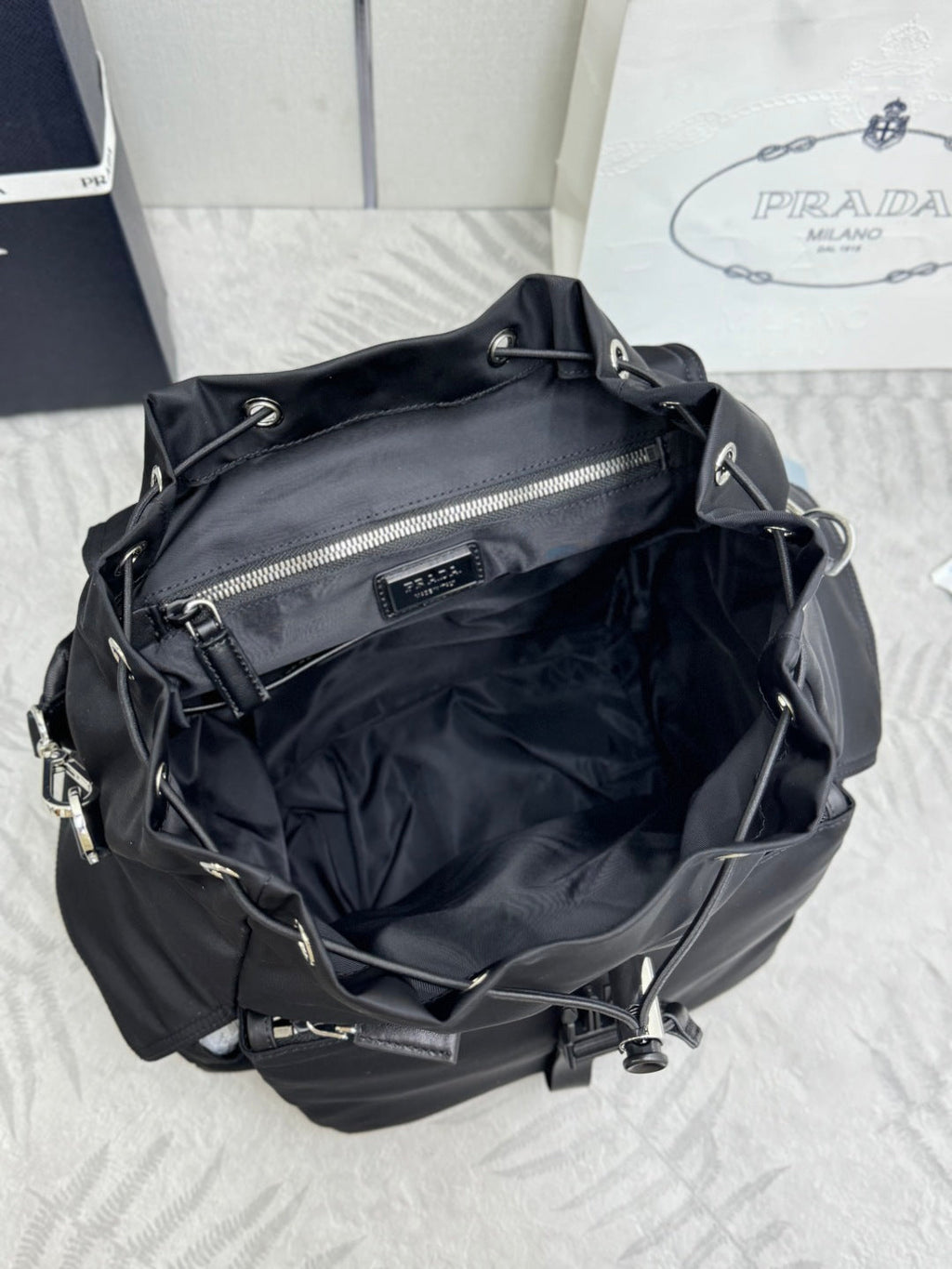 PRADA 25S EXPLORE BACKPACK 39 IN BLACK RE-NYLON AND CALFSKIN