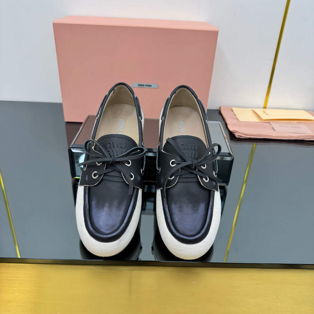 BOAT SHOES IN BLACK CALFSKIN AND WHITE CANVAS