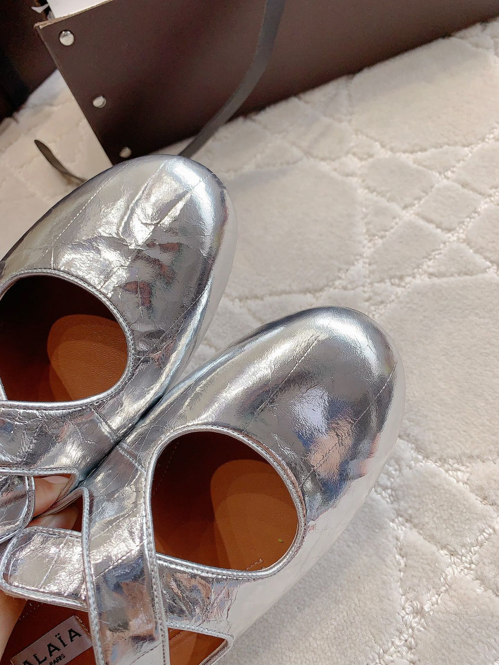 ALAIA CRISS CROSS BALLET FLAT IN SILVER LAMBSKIN