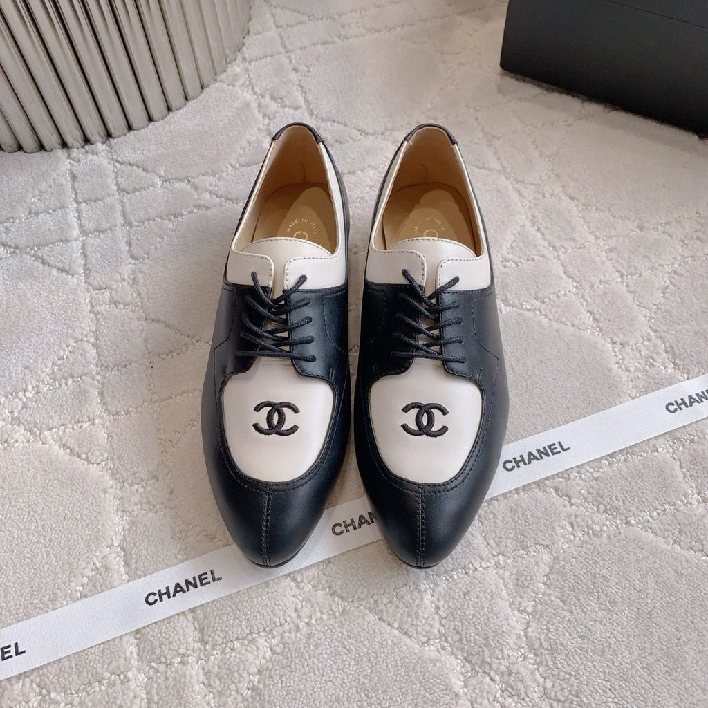 CHANEL 25S TWO TONE LACE UP IN BLACK AND WHITE CALFSKIN