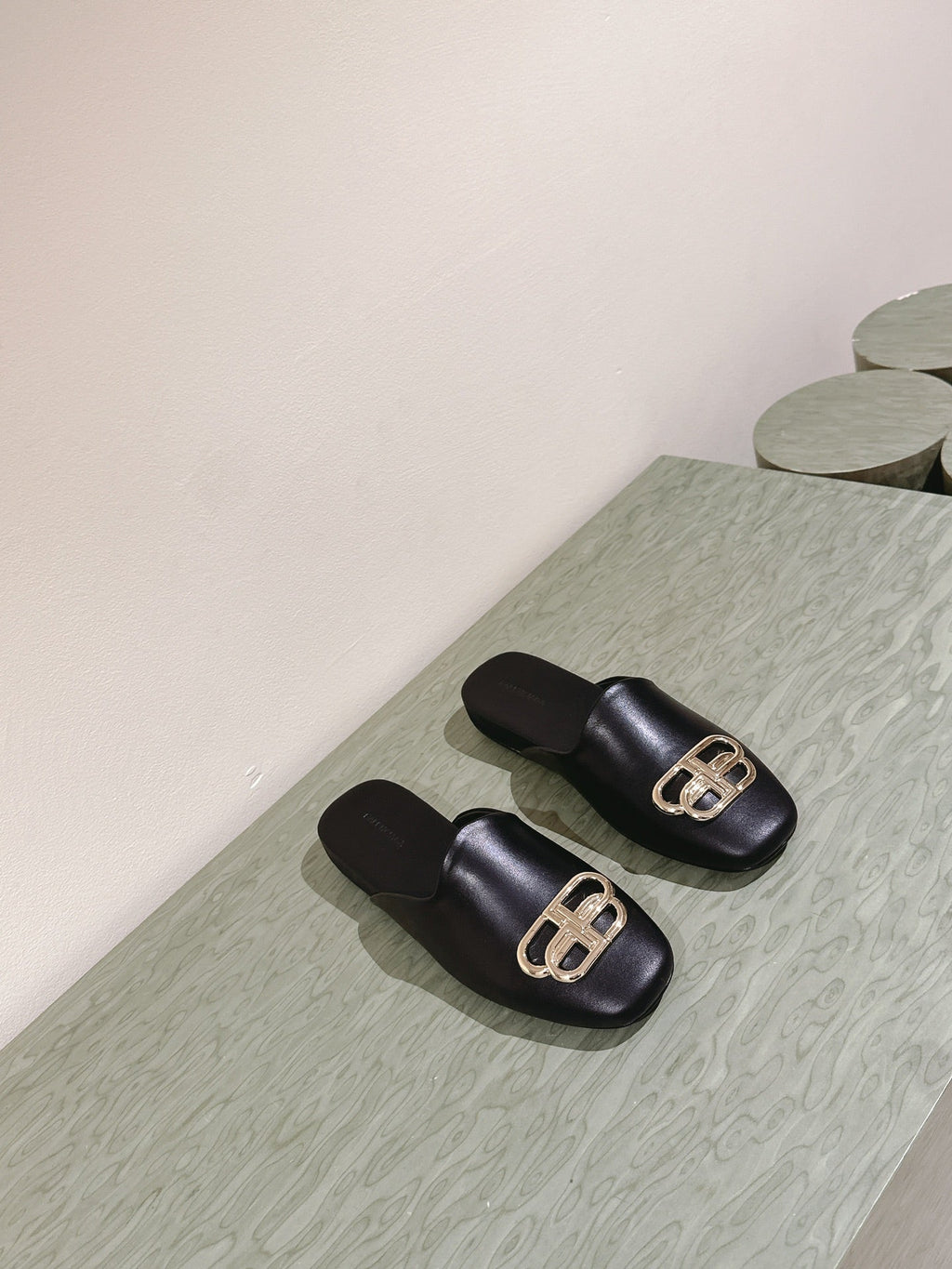 FLAT MULES IN BLACK SMOOTH CALFSKIN GOLD BUCKLE