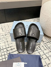 PRADA 25S PADDED SLIDES IN BLACK CALFSKIN WITH LOGO