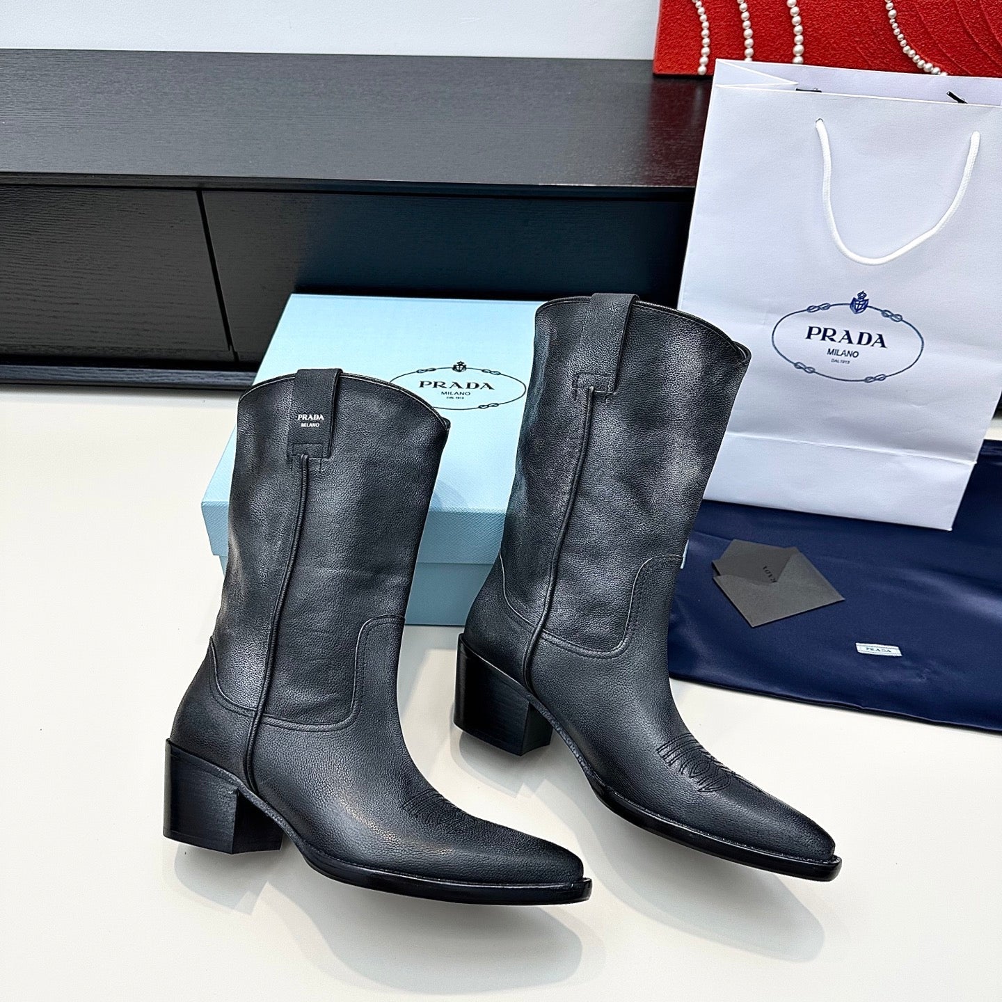 PRADA 25S POINTED-TOE LOW-CUT BOOTS IN BLACK COWHIDE