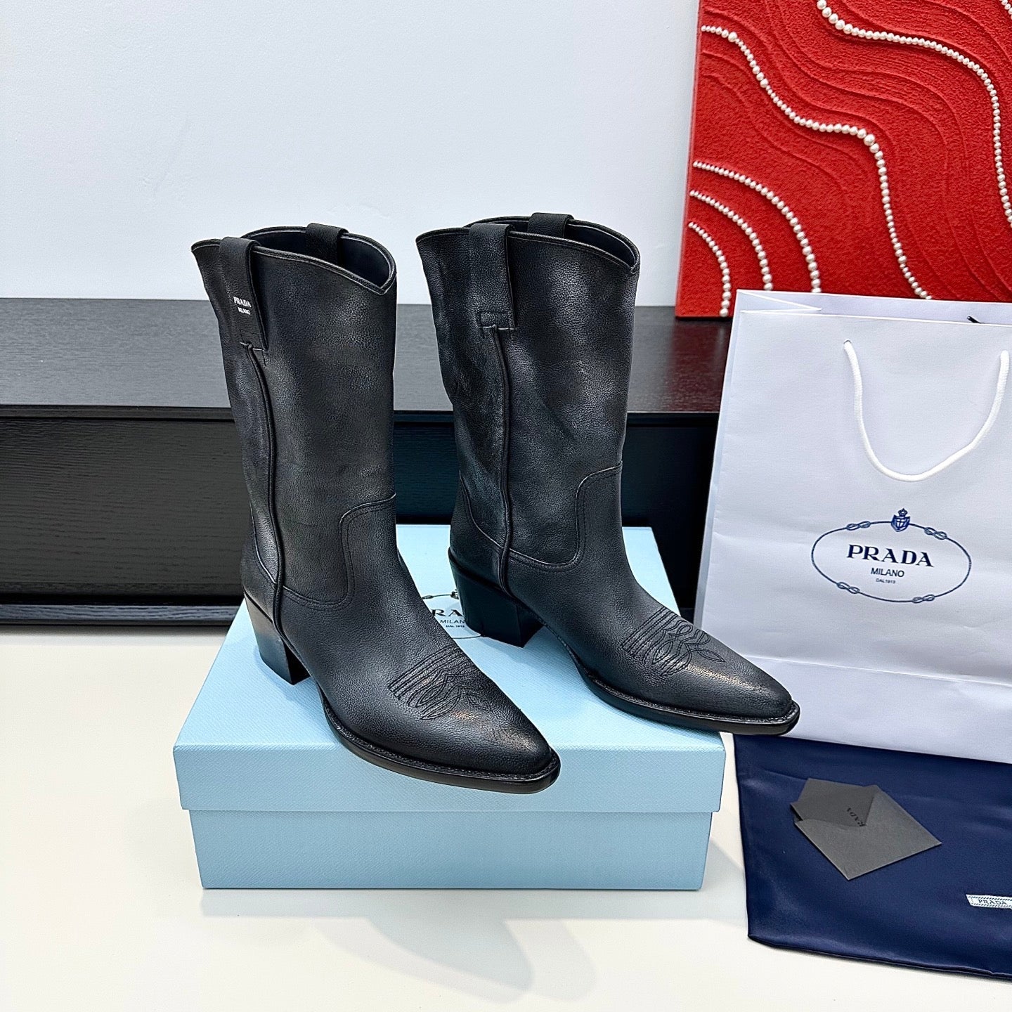 PRADA 25S POINTED-TOE LOW-CUT BOOTS IN BLACK COWHIDE