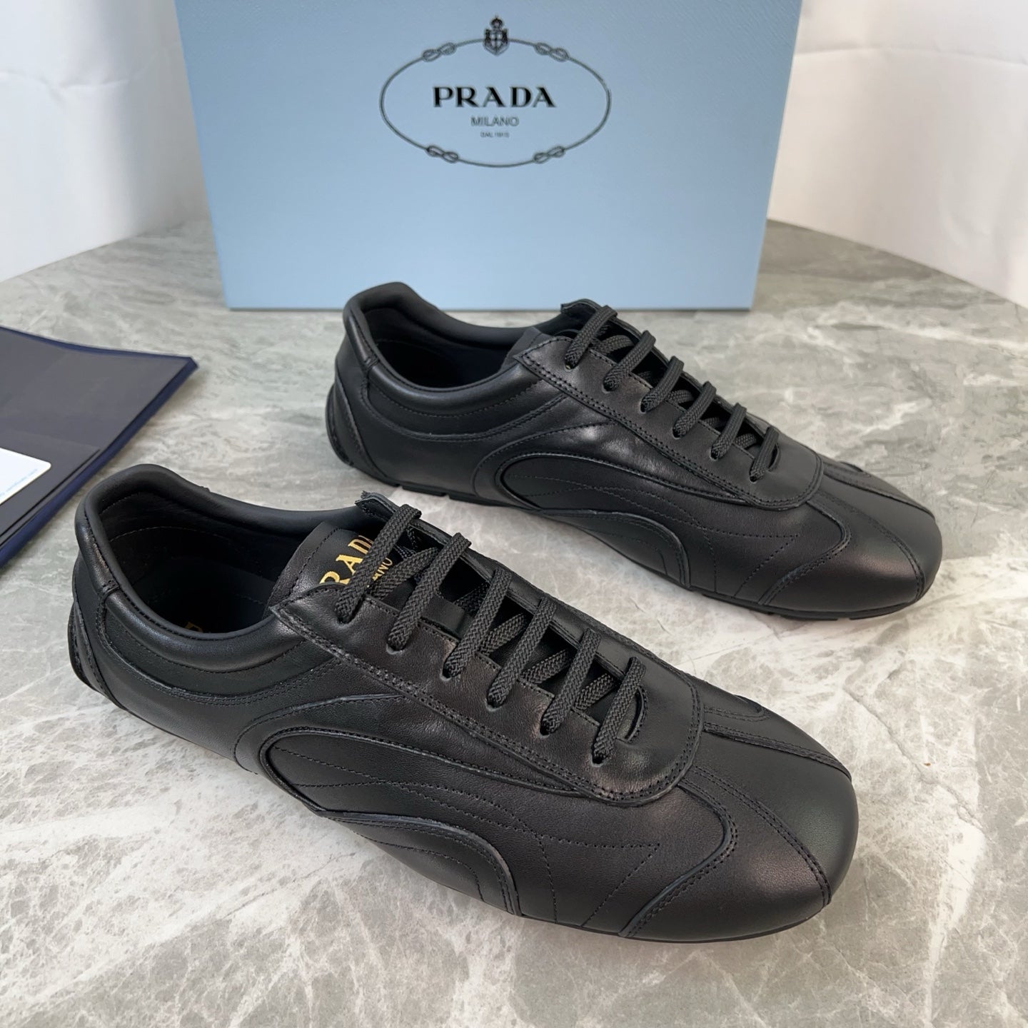 PRADA 25S MONTECARLO ANTIQUED SNEAKERS IN BLACK NAPPA LEATHER