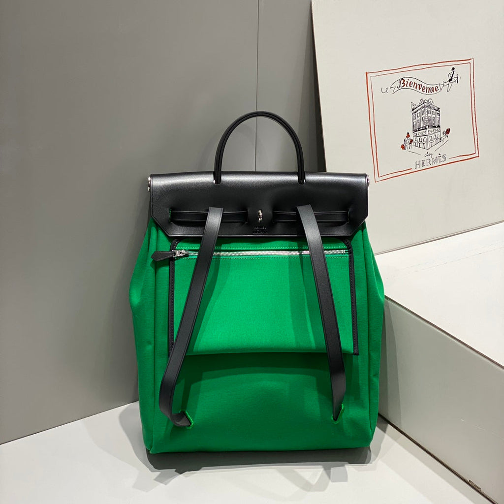HERBAG A DOS ZIP RETOURNE BACKPACK 29 IN GREEN CANVAS AND BLACK CALFSKIN