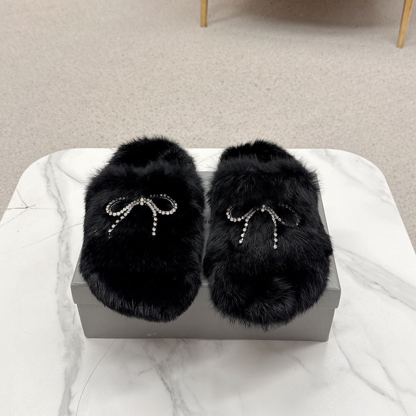 BALENCIAGA 25S SOFT FUR SLIPPERS IN BLACK FUR WITH RHINESTONE BOW