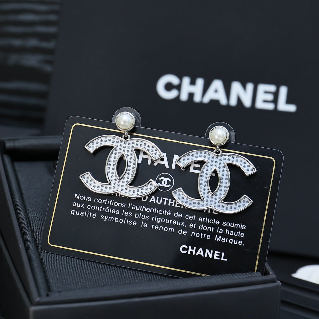 DOUBLE C EARRINGS IN SILVER METAL WITH BLACK SNOWFLAKE EMBOSSED ON WHITE ENAMEL