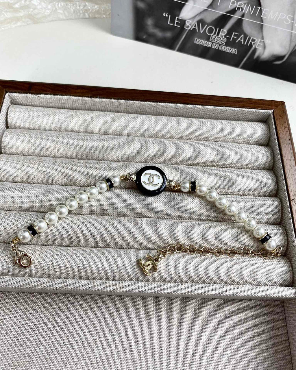 Classic CC bracelet with faux pearls and black resin.