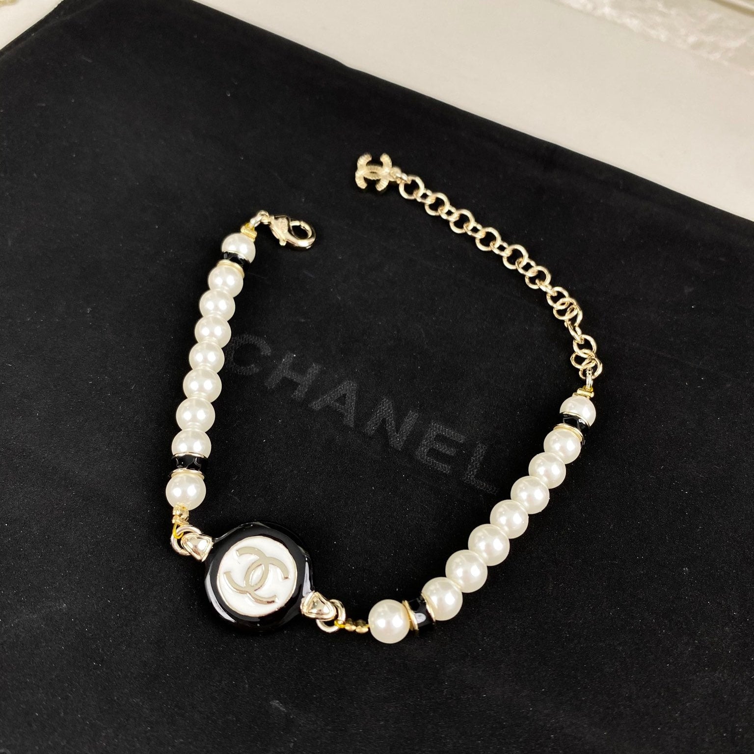 Classic CC bracelet with faux pearls and black resin.