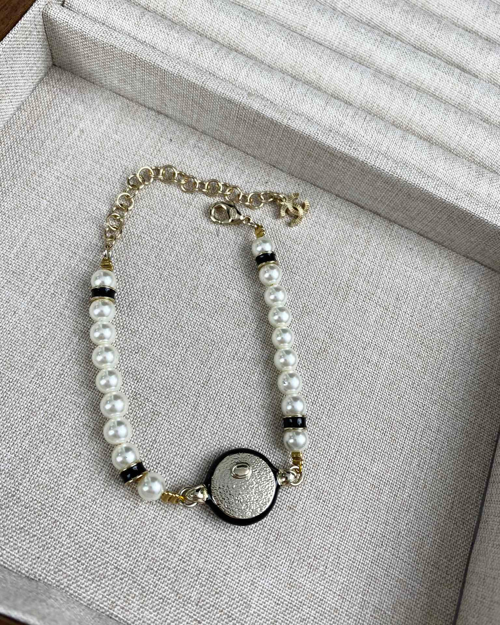 Classic CC bracelet with faux pearls and black resin.