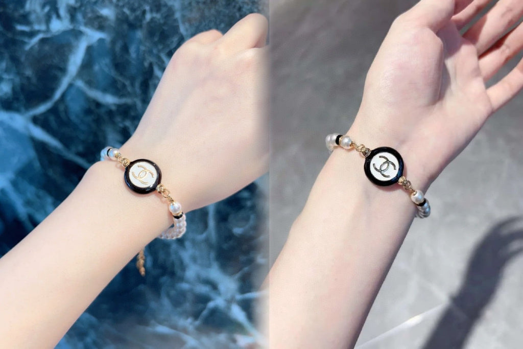 Classic CC bracelet with faux pearls and black resin.