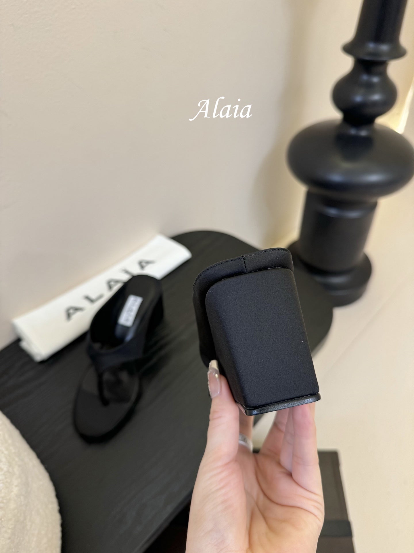 ALAIA WEDGE THONG SANDALS 25S IN BLACK SATIN