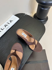 ALAIA WEDGE THONG SANDALS 25S IN BROWN SATIN