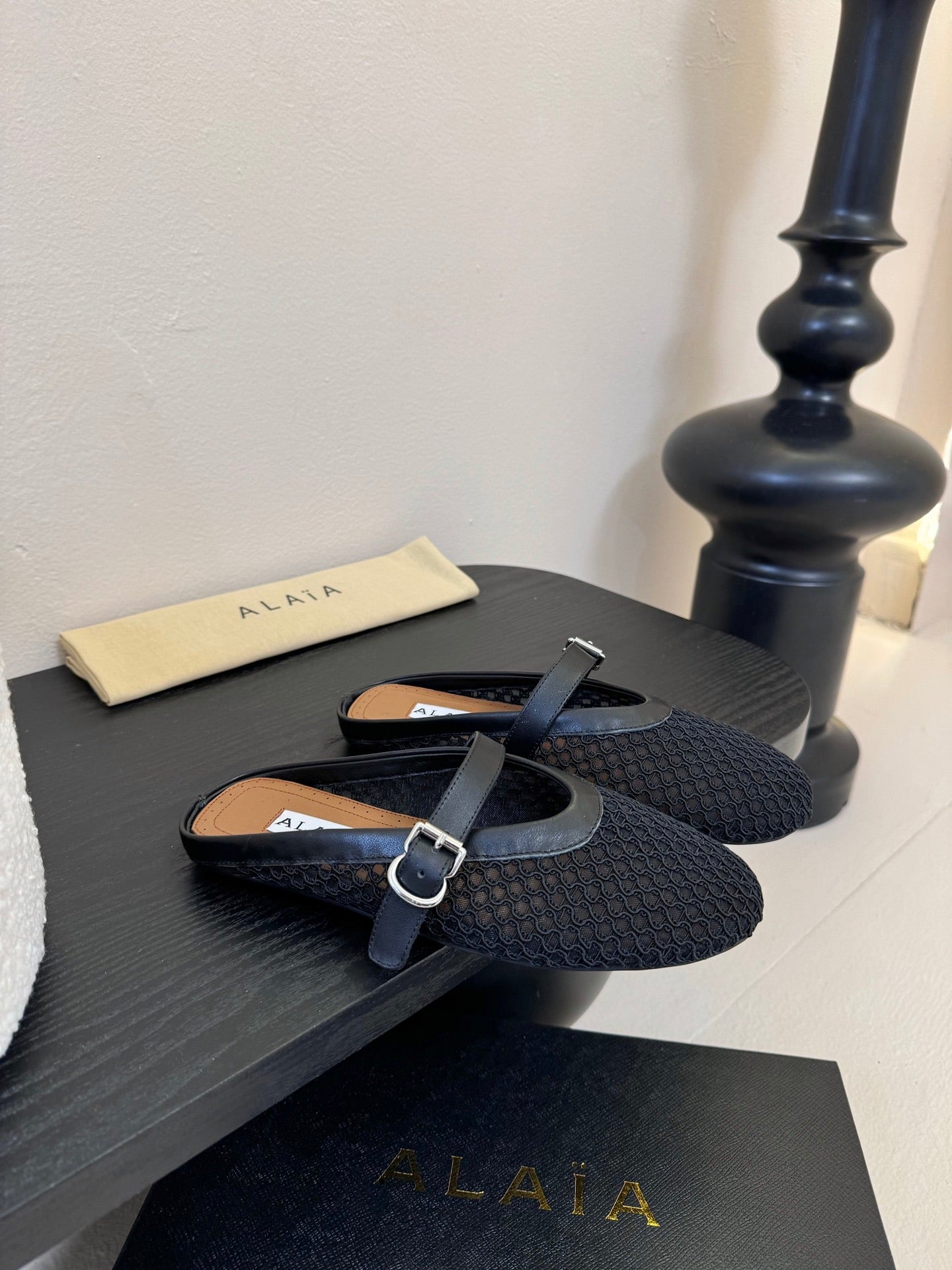 ALAIA FLAT MULES 25S IN BLACK WOVEN MESH