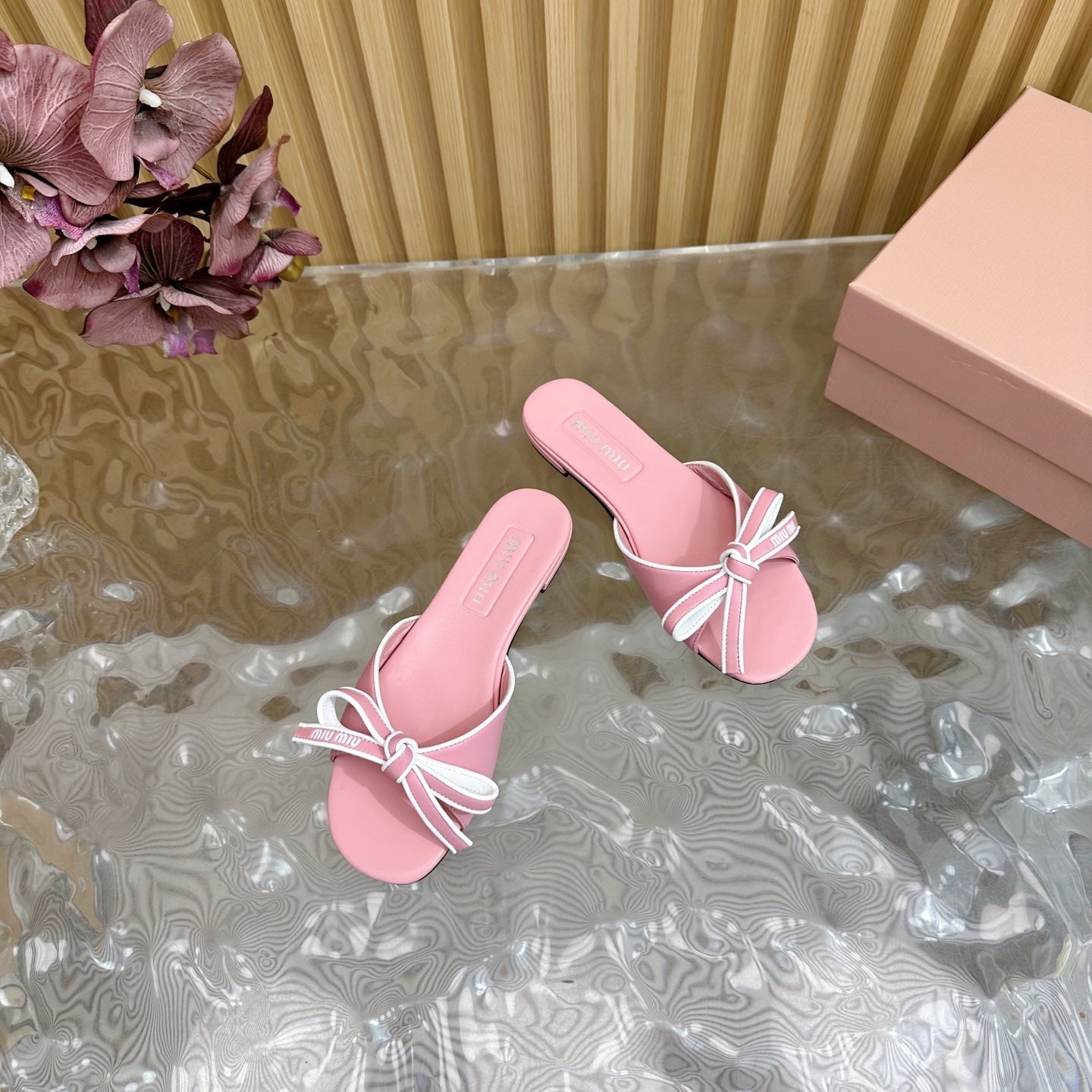 SLIDES SANDALS IN PINK CALFSKIN WITH BOW IN TRAP
