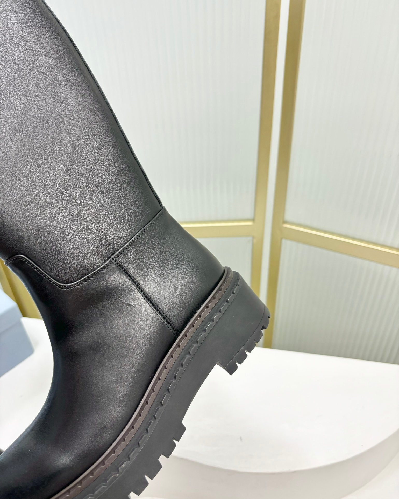 KNEE BOOTS WITH TRIANGLE LOGO IN BLACK CALFSKIN