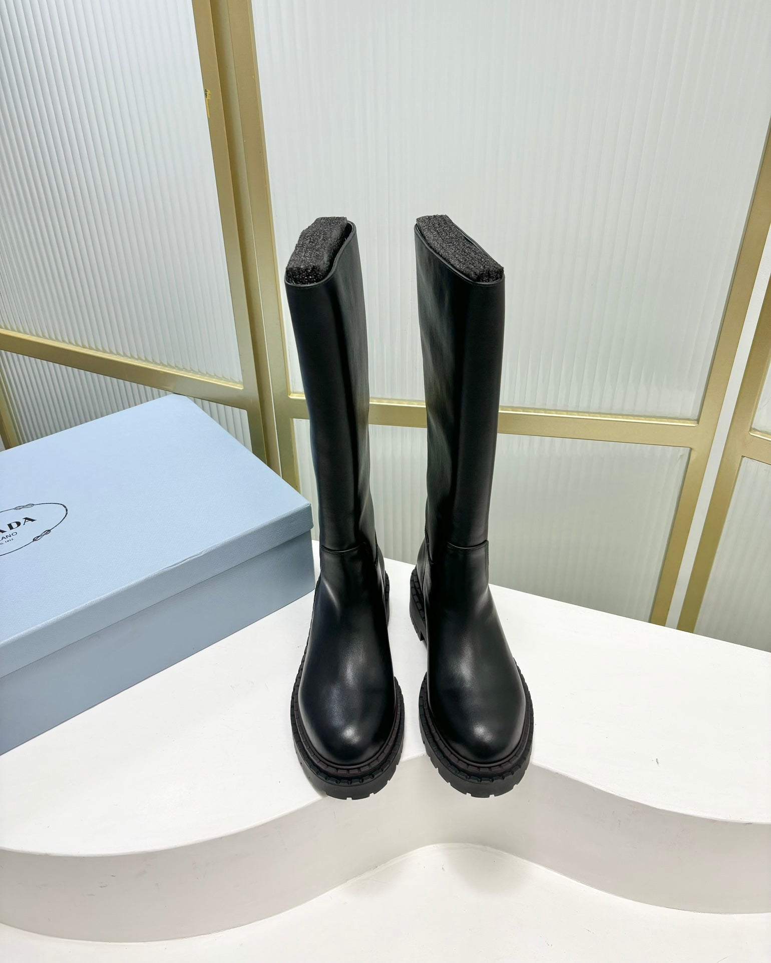 KNEE BOOTS WITH TRIANGLE LOGO IN BLACK CALFSKIN