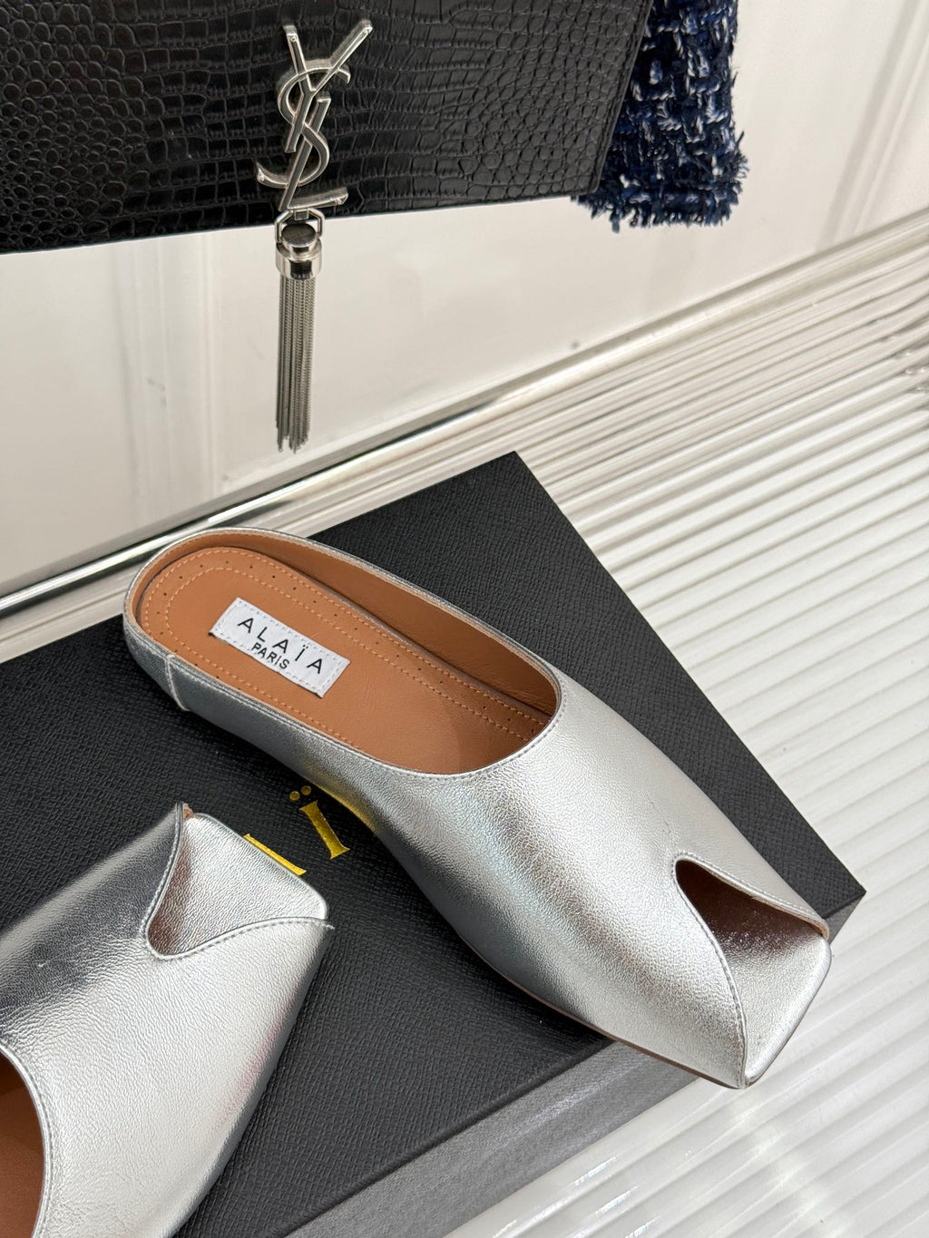 ALAIA FLAT MULE IN SILVER LAMBSKIN