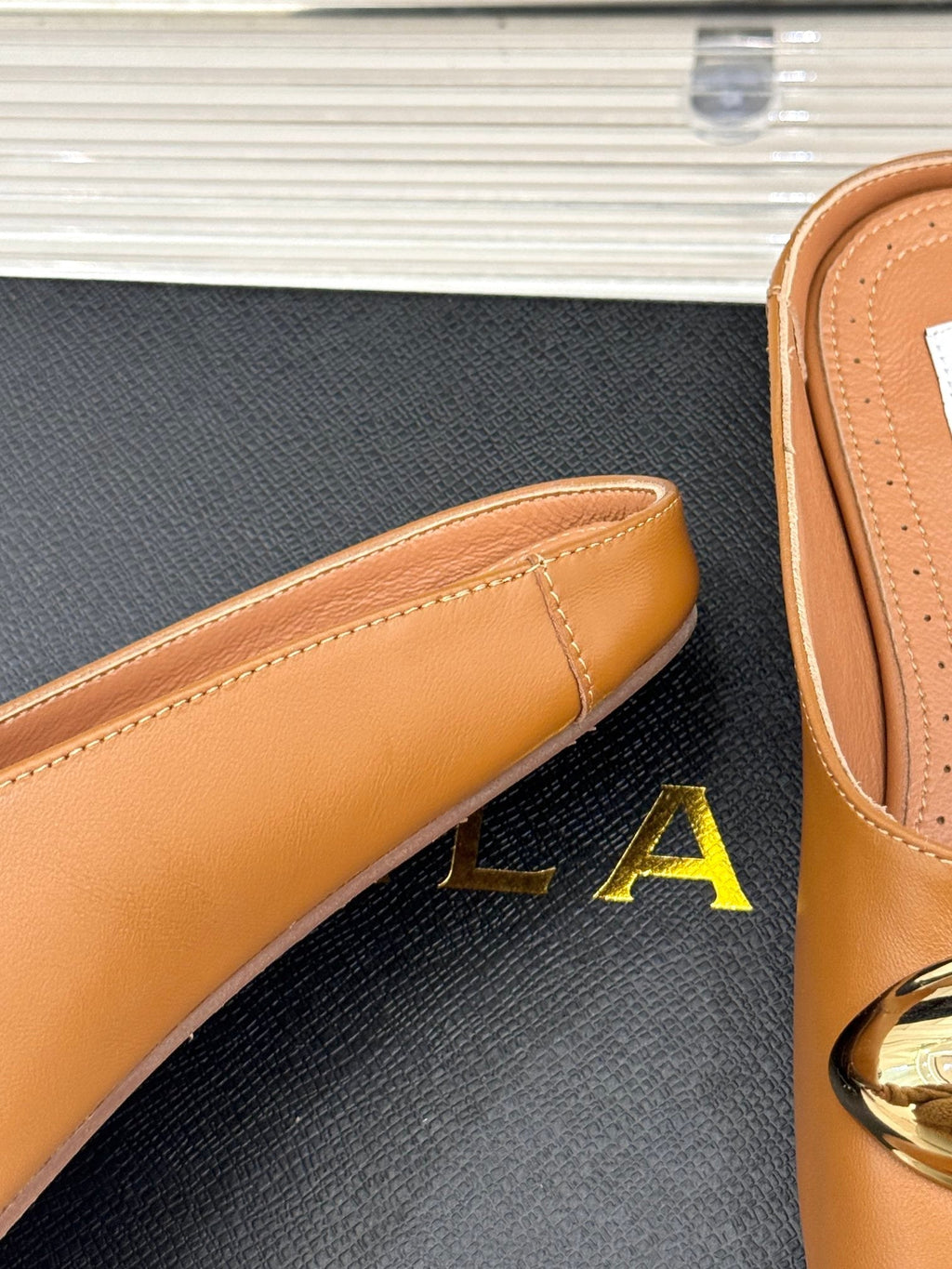 ALAIA FLAT MULE IN BRONZE BROWN LAMBSKIN WITH GOLD HARDWARE