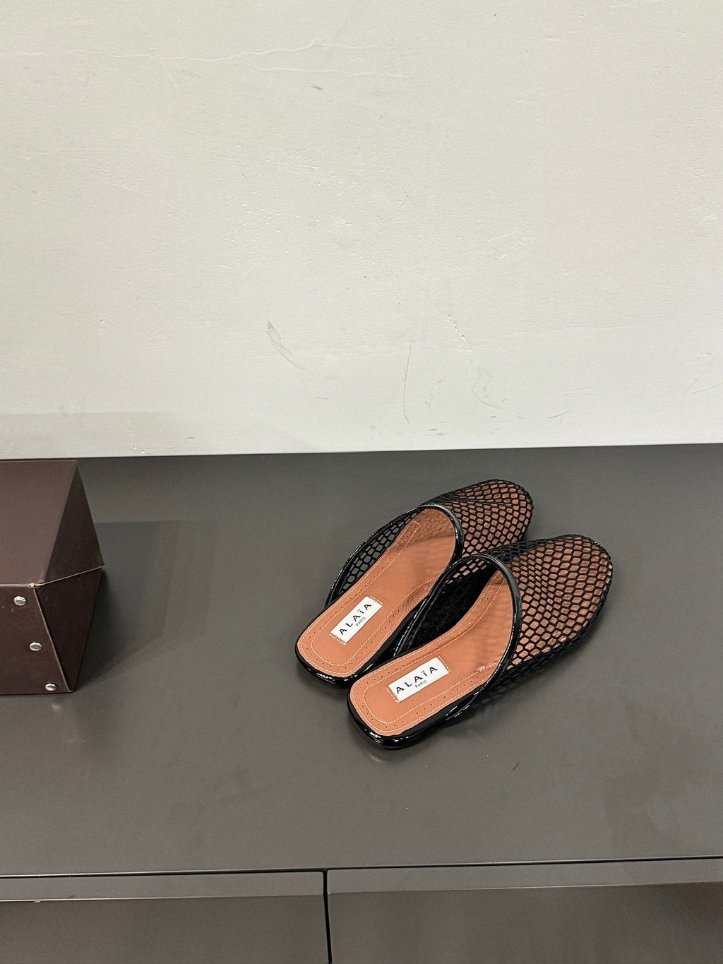 ALAIA FLAT MULES IN BLACK MESH FISHNET